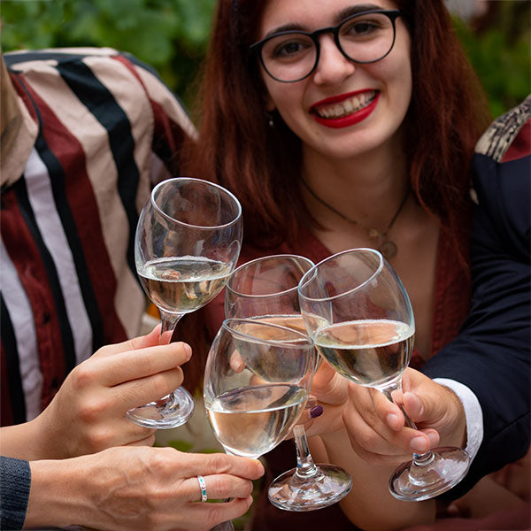 Glasses of wine held together in cheers with a smiling model